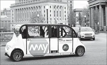  ?? David L. Ryan Boston Globe ?? A MAY MOBILITY self-driving vehicle cruises through Providence, R.I. May has managed to get a public shuttle service going by keeping it simple, providing slow rides on easy fixed routes that serve a specific need.