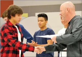  ?? TIMES photograph by Annette Beard ?? Junior Blackhawk cross country runner Kevin Vasquez was presented the Blackhawk Pride award for Cross Country by coach John E. King during the fall sports awards ceremony.