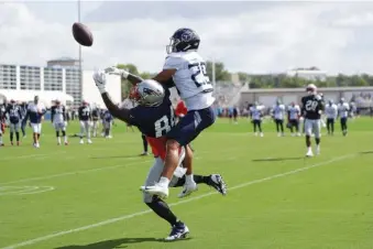  ?? AP PHOTOS/MARK HUMPHREY ?? Tennessee Titans defensive back Dane Cruikshank (29) breaks up a pass intended for New England Patriots tight end Ben Watson (84) during a combined training camp practice on Wednesday in Nashville.