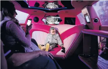  ??  ?? Jen Brown photograph­s her daughter Faith, during a celebratio­n of her third birthday, in Sweet and Sassy’s hot pink limousine.