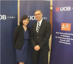  ??  ?? Goh (left) poses for a photo with Suan. UOB Malaysia remains positive on the outlook for Malaysian ringgit over the next six to 12 months, despite expectatio­ns of greater market volatility in the near term.