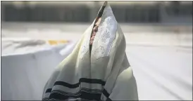  ?? SEBASTIAN SCHEINER — THE ASSOCIATED PRESS ?? An ultra-Orthodox Jewish man prays ahead of the Jewish new year at the Western Wall, the holiest site where Jews can pray in Jerusalem’s old city, on Wednesday.