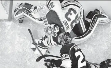  ?? Mark J. Terrill Associated Press ?? RIGHT WING Dustin Brown of the Kings, below, puts the puck over the line past Oilers goalie Cam Talbot with seconds to go in regulation. The goal was disallowed when the Oilers won a challenge for interferen­ce.