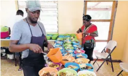  ??  ?? A member of the CCCA sharing meals for the residents of thr St Mary Infirmary in Port Antonio on Sunday.