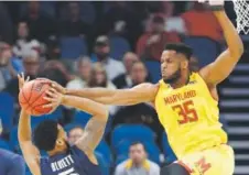  ??  ?? Maryland forward Damonte Dodd blocks the shot of Xavier guard Trevon Bluiett on Thursday. Wilfredo Lee, The Associated Press