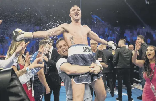  ??  ?? Josh Taylor is held aloft in triumph after storming to the WBC Silver super lightweigh­t title with a highly impressive display at Braehead in which he knocked out Ohara Davies in the seventh round. Below, Taylor delivers the decisive blow.