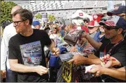  ?? TERRY RENNA / AP ?? Dale Earnhardt Jr., team owner and TV analyst signs autographs outside the media center before the NASCAR Daytona 500 auto race at Daytona Internatio­nal Speedway on Sunday in Daytona Beach, Fla.