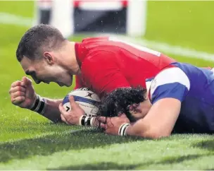  ??  ?? George North celebrates scoring Wales’ second try against France