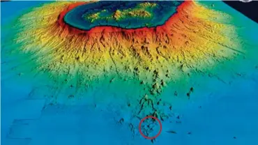  ?? ?? ▼Vue bathymétri­que 3D de Mayotte et du talus océanique autour du lagon. Campagne Mayobs-2 de mai 2019 (CNRS / IPGP / Université de Paris / IFREMER / BRGM). Le nouveau volcan se situe dans le rond rouge en bas de l’image à 50 km de Petite Terre.