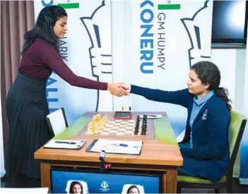 ?? — FIDE ?? Dronavali Harika (left) and Koneru Humpy prior to their ninth round action at the Cairns Cup Chess Tournament in St. Louis on Monday.