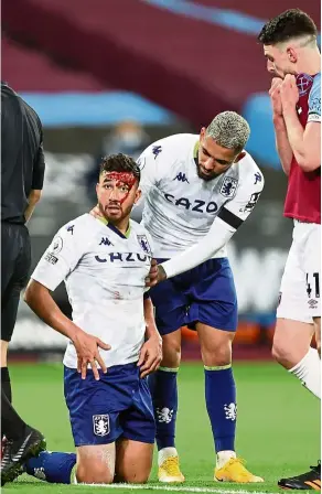  ?? — Reuters ?? Bloodied: Aston Villa’s Trezeguet (left) reacts after sustaining a cut to the head against West Ham.