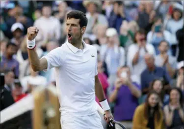  ?? TIM IRELAND — THE ASSOCIATED PRESS ?? Serbia’s Novak Djokovic celebrates after beating United States’ Denis Kudla in a Men’s singles match during day three of the Wimbledon Tennis Championsh­ips in London Wednesday.