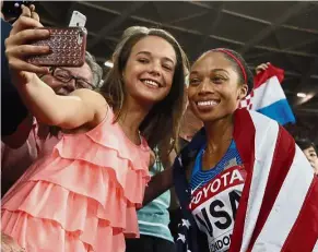  ?? — AP ?? Say cheese: American women’s 4x400m relay gold medallist Allyson Felix (right) posing for a selfie with a fan.