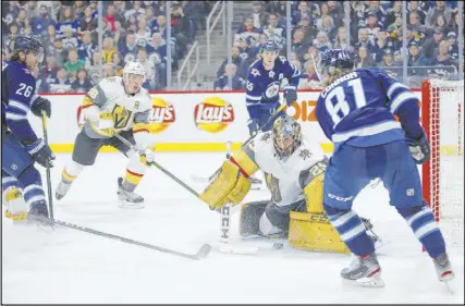  ?? John Woods The Associated Press ?? Knights goaltender Marc-Andre Fleury stops a shot from Jets left wing Kyle Connor in a 4-0 loss Friday night in Winnipeg, Alberta. The Knights play at Calgary on Sunday and at Edmonton on Monday.