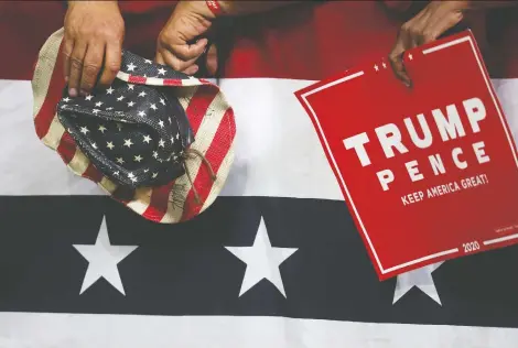  ?? LEAH MILLIS/REUTERS ?? Supporters hold a hat and sign as U.S. President Donald Trump holds a campaign rally in Minneapoli­s on Thursday. Uncertaint­y may be the word for the next four years if Trump gets re-elected, and equity markets can’t stand uncertaint­y, says Peter Hodson.