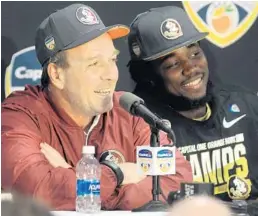 ?? TOM CRAIG/FOR THE SUN SENTINEL ?? Coach Jimbo Fisher and Seminoles running back Dalvin Cook, right,speak after the game Friday. Cook later said he would make himself eligible for the 2017 NFL draft.