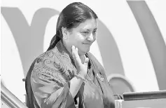  ??  ?? Nepal’s President Bidya Devi Bhandari waves as she disembarks from an aircraft on her arrival at Bandaranai­ke Internatio­nal Airport for a visit to Sri Lanka in this file photo. — AFP photo