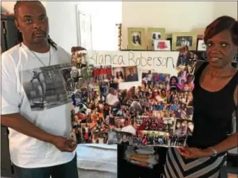  ?? ROSE QUINN – DIGITAL FIRST MEDIA ?? Bianca Roberson’s parents, Rodney and Michelle Roberson, hold a collage of photos of their daughter Bianca.