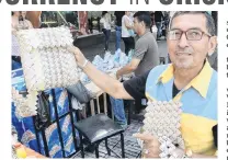  ?? PHOTO: TNS ?? Cash supply an art supply . . . One thousand Venezuelan bills went into making the purse being held up by Alvaro Rivera in Cucuta, Colombia. As Venezuela’s bolivar has lost its value, artisans say it is worth more as a raw material than as a currency.