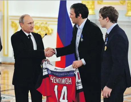  ?? YURI KADOBNOV/THE CANADIAN PRESS ?? Russian President Vladimir Putin, left, can count on the support of many of Russia’s top sports stars including Alex Ovechkin, centre, in this weekend’s upcoming presidenti­al election.