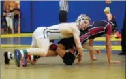  ?? AUSTIN HERTZOG - DIGITAL FIRST MEDIA ?? Spring-Ford’s Brandon Meredith finishes a takedown of Lower Merion’s Christian Hodges during the 120-pound final at the District 1-AAA Central Tournament .