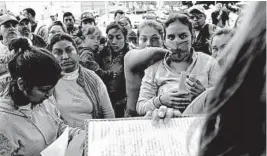  ?? GREGORY BULL/AP ?? Women wait to be called this week in Tijuana, Mexico, to cross the border and request asylum.