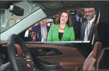  ?? REBECCA COOK / REUTERS ?? Michigan Governor Gretchen Whitmer looks at the interior of a Chevrolet Traverse during the North American Internatio­nal Auto Show in Detroit, Michigan, on Tuesday.