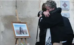  ?? ANNE- CHRISTINE POUJOULAT / AFP / GETTY IMAGES ?? Relatives of the victim Mauranne take part in a tribute next to her portrait on Monday in Eguilles, France.