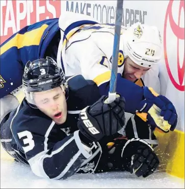  ?? Photograph­s by Harry How Getty Images ?? BRAYDEN McNABB (3) of the Kings collides with Eric Nystrom of the Predators along the boards in the third period. It was the first game since Jan. 1 that the Kings won after trailing heading into the third period.