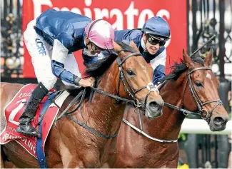  ?? PHOTOS: GETTY IMAGES ?? Rekindling, ridden by Corey Brown (left) wears down Johannes Vermeer (Ben Melham) in the closing stages of the Melbourne Cup yesterday.