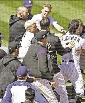  ?? GETTY ?? Benches clear at Coors Field Wednesday as tensions boil over into all-out brawl.
