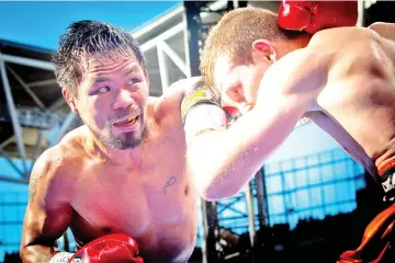  ?? — AFP photo ?? This file photo taken on July 2, 2017 shows Manny Pacquiao (L) of the Philippine­s fighting Jeff Horn (R) of Australia during their World Boxing Organizati­on bout at Suncorp Stadium in Brisbane.