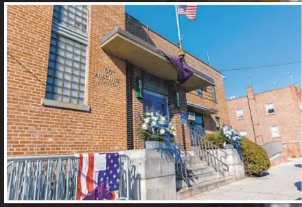  ?? ?? Randy “Popper” Jones is led from the NYPD’s 75th Precinct stationhou­se in Brooklyn on Tuesday. On Wednesday he was formally charged with murder. Flowers are left at stationhou­se in Brooklyn where fallen Officer Adeed Fayaz worked.