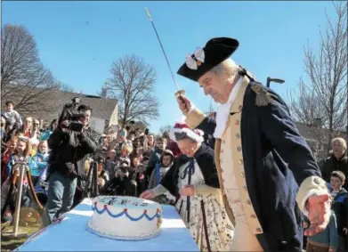  ?? GENE WALSH — DIGITAL FIRST MEDIA ?? General George Washington re-enactor John Lopes bows to visitors at Valley Forge National Historical Park after he cut into his birthday cake during the park’s annual Presidents Day celebratio­n Monday.