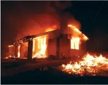  ?? THE ASSOCIATED PRESS ?? A home is engulfed in a fire caused by a fast burning wildfire in the section of South Lake near Lake Isabella, Calif., on Friday.