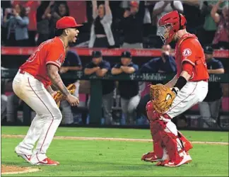  ?? Wally Skalij Los Angeles Times ?? FELIX PENA, who pitched the last seven innings and gave up only a walk, celebrates with catcher Dustin Garneau after the final out. It was the second combined no-hitter in team history.