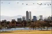  ?? THOMAS PEIPERT/AP ?? The Denver skyline, with not a flake in sight, Friday. The city has broken its 87-year-old record for the latest measurable snowfall, set in 1934.