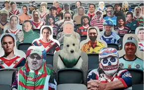  ??  ?? Cardboard cut-outs of fans and their dogs are placed in seats around the stadiums during NRL matches.