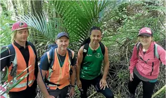  ?? PHOTOS: CHRISTINA PERSICO/STUFF ?? Surveyor Thomas Burley, project manager Stefan Kiss, Nga Mahanga a Tairi representa­tive Ta¯ne Manu and reporter Christina Persico on the paper road that will soon be a walking track.