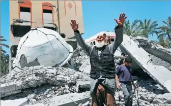  ?? ASHRAF AMRA VIA GETTY IMAGES ?? A Palestinia­n reacts near the debris of Abu Bakr Al-Siddiq mosque and surroundin­g buildings in Deir al-Balah following an Israeli attack in the Gaza Strip on Saturday.