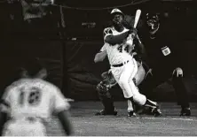  ?? Associated Press file photo ?? Hank Aaron eyes the flight of the ball as it soars out of the park for home run No. 715, crowning him baseball’s homer king in 1974.