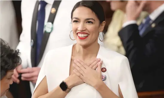  ?? WIN MCNAMEE/GETTY IMAGES ?? U.S. Rep. Alexandria Ocasio-Cortez, D-N.Y., greets fellow lawmakers ahead of the State of the Union address on Feb. 5.