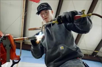  ?? Mark Zaleski/Associated Press ?? Boone Willams, 20, brazes a copper pipe during a second-year apprentice training program class at the Plumbers and Pipefitter­s Local Union 572 facility in Nashville, Tenn.