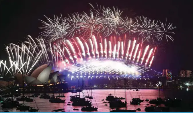  ??  ?? Fireworks light the sky over the Opera House and Harbor Bridge during New Year’s Eve celebratio­ns in Sydney early yesterday. — AFP photos