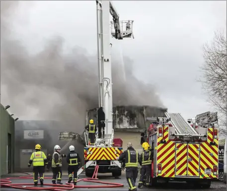  ??  ?? Fire personnel tackle the blaze at Finisklin Road on Saturday afternoon. Pics by Donal Hackett.