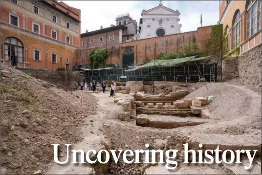  ?? ?? People walk Wednesday in the excavation site of the ancient Roman emperor Nero’s theater, back-dropped by the church of Santo Spirito in Sassia, during a press preview in Rome. (AP/Andrew Medichini)