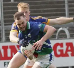  ??  ?? The outstandin­g Mark Fanning is tackled by Gusserane’s Liam Dillon.