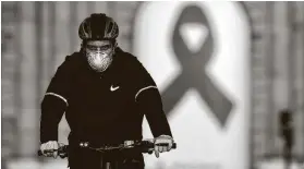  ?? Gabriel Bouys / AFP via Getty Images ?? A cyclist rides in Madrid on Saturday, during the hours allowed by the government to exercise for his age group.