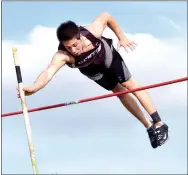  ?? Photo by Mike Eckels ?? Gentry’s Cole Cripps pushes away his pole as he clears the bar during the pole vault event. Cripps finished in second place after matching Owens’ vault.