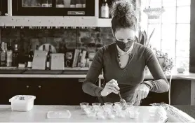  ?? Photos by David Kasnic / New York Times ?? Jessica Line prepares takeout orders atWherewit­hall, a restaurant with the same owners as Parachute, in the Avondale neighborho­od of Chicago.